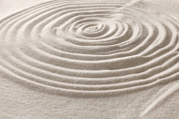 Fototapeta na wymiar Pattern drawn on white sand, closeup. Zen garden