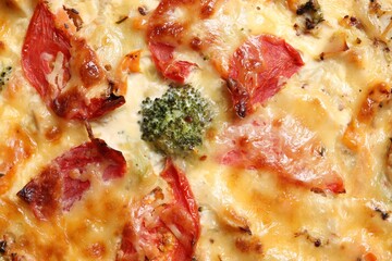 Tasty quiche with cheese and tomatoes as background, top view