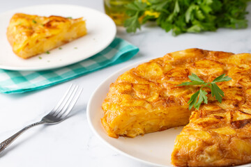 Spanish omelette with potatoes, typical spanish cuisine on gray concrete floor. Tortilla Espanola. Turkish name; Yumurtali patates