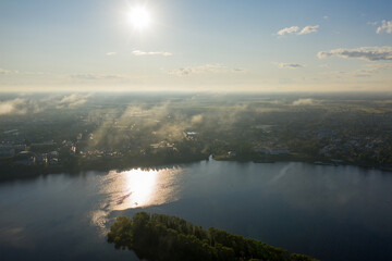 Uglich, Russia. Flying in the clouds. The Volga river embankment in the backlight. Aerial view