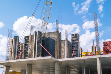 The foundation on reinforced concrete piles and the frame during the construction of a multi-storey building. Reinforcement of reinforced concrete columns. Construction of high-rise buildings.