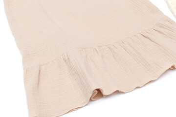 A set of children's clothes for a child. A sundress made of muslin in beige tones