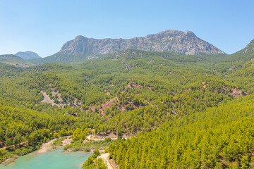 Fototapeta na wymiar Aerial view of National Park Turkey. Wooden Lake reservoir forest among rocky mountains and peaks.
