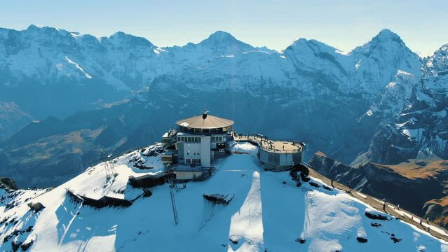 aerial view of the Schilthorn piz Gloria: circling flight over the station in an autumnal landscape on a sunny day.