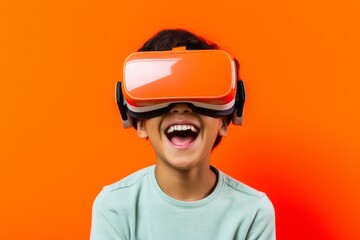 Headshot portrait photography of a joyful boy in his 20s playing with virtual reality mask against a bright orange background. With generative AI technology