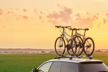 Transporting Bicycles on Car Roof for a Summer Adventure. Exploring the Open Road. Mountain bike and other equipment transportation on the roof.