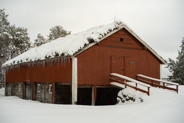 Snow covered landscape with old houses in Norway