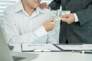 Businessmen receive salary or bonuses from management or Boss. Company give rewards to encourage work. Smiling businessman enjoying a reward at the desk in the office.