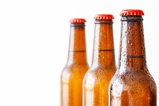 Close-up of three cropped beer bottles
