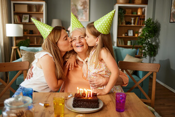 Mother, daughter and grandmother at birthday party at home