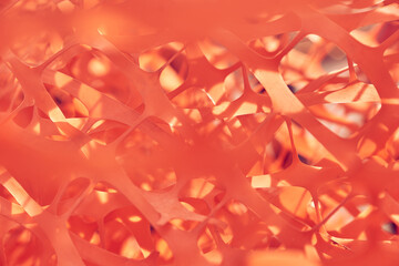 Selective focus on building supplies a bunch of orange mesh for reinforcing walls in the process of warming a building outdoors. High quality photo