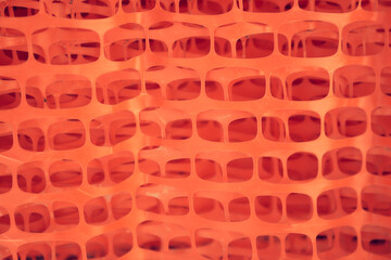 Reinforcing mesh for plaster. Orange construction mesh in rolls in a hardware store. Mesh for reinforcing walls in the process of their insulation, rolled into a roll. High quality photo