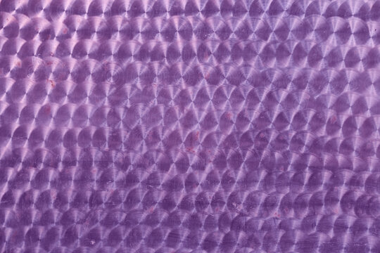 A holographic surface of lilac color with space for copying. Iridescent film texture. High quality photo