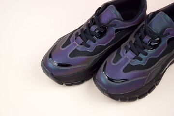 Bright female sneakers on light pink background. Fashion blog or magazine concept.