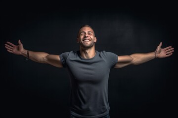 Lifestyle portrait photography of a beautiful boy in his 30s extending arms to one side in a gesture of freedom against a dark grey background. With generative AI technology