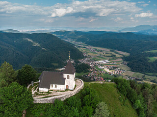 Fototapeta premium Church Saint Lawrence at the top of Mount Polhov Gradec aka Mount Saint Lawrence Hill in the Polhov Gradec.