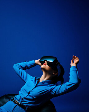 Futuristic minimal cyber neon portrait of young girl wearing VR glasses, life in virtual reality. Technological progress and the use of artificial intelligence.