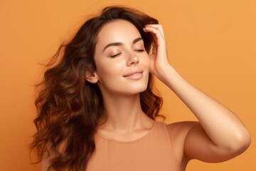 Obraz premium Lifestyle portrait photography of a glad girl in her 30s putting the hand on the forehead to look for someone in the distance against a pastel orange background. With generative AI technology