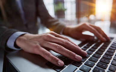 Close-up of male hands using laptop at office