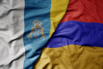 Fototapeta premium big waving national colorful flag of canary islands and national flag of armenia .