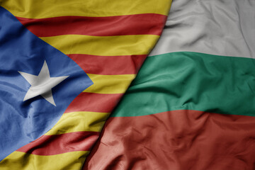 big waving national colorful flag of catalonia and national flag of bulgaria .