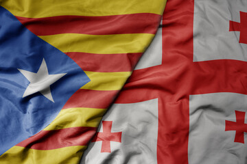 big waving national colorful flag of catalonia and national flag of georgia .