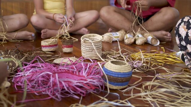 Circle Of Women Weaving Traditional Maori Baskets.