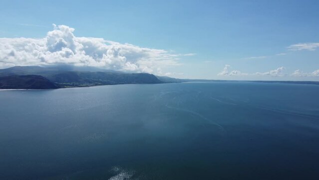 Breathtaking ocean view from a high flying drone of the Northern Welsh coast and mountains of Snowdonia from the Great Orme