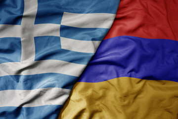 big waving national colorful flag of greece and national flag of armenia .