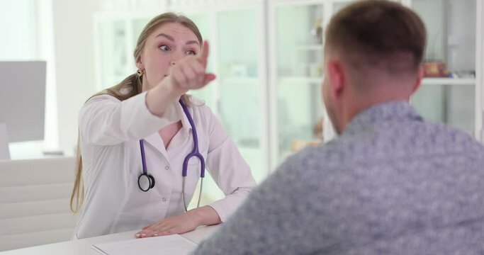 Angry physician kicks male patient out of exam room for inappropriate behaviour. Drunk male leaves examination room in private hospital