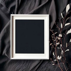 Mockup blank photo frame and branches on dark cotton fabric top and vertical view