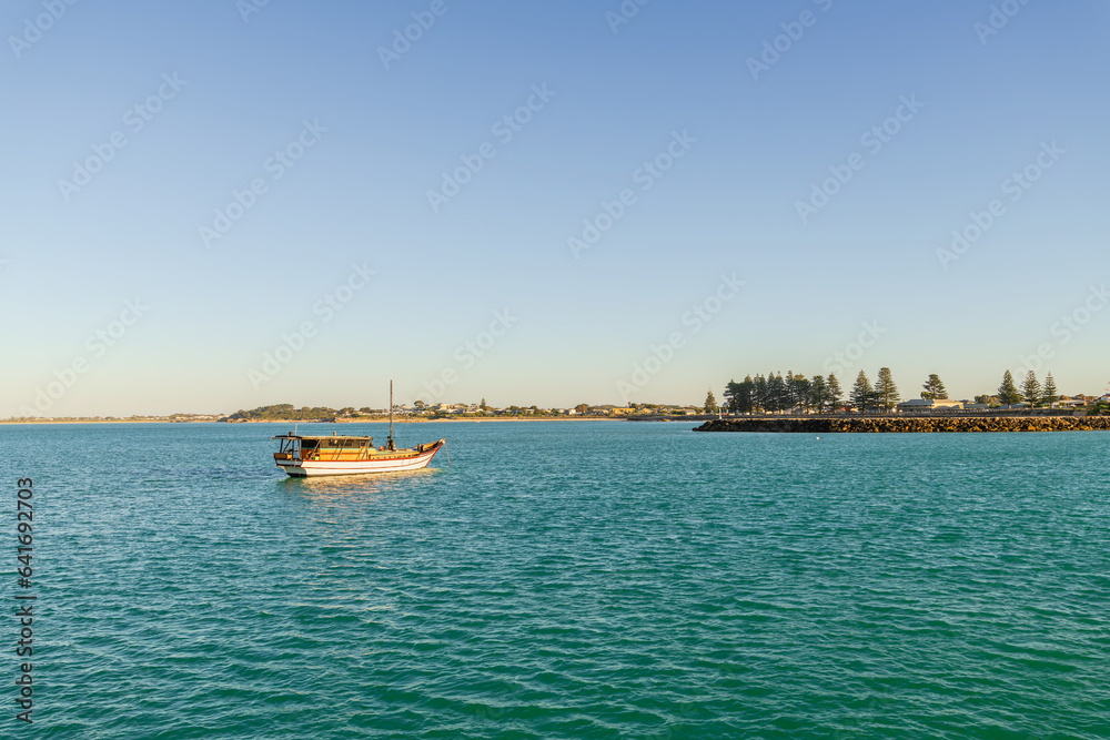 Wall mural Vintage fishing boat anchored in Guichen Bay near Robe at sunset, Limestone Coast, South Australia