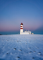 Alnes lighthouse in a winter sunset, Godøy, Ålesund, Norway - obrazy, fototapety, plakaty
