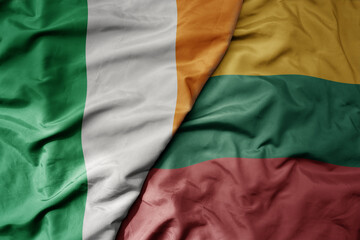 big waving national colorful flag of ireland and national flag of lithuania .