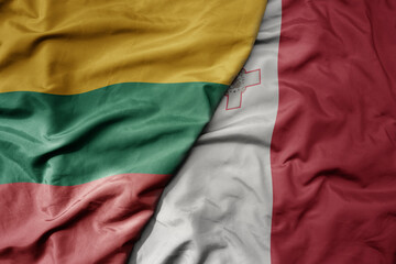 big waving national colorful flag of lithuania and national flag of malta .