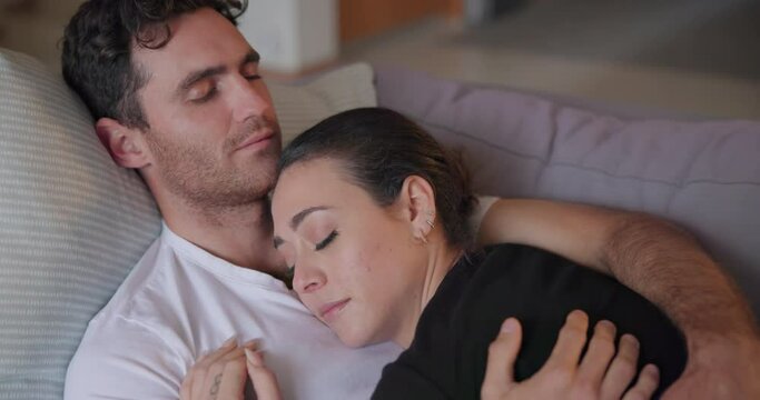 Couple, sleeping and relax on sofa together for dreaming, comfort and support at home. Face of calm man, tired woman and cuddle for peaceful resting, cozy nap and hug partner for love in living room