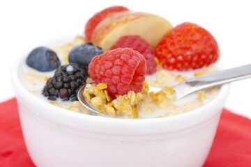 Wholesome Breakfast Featuring Creamy Oatmeal Adorned with Fresh Berries and Crunchy Granola: A Nutritious and Inviting Start to the Day