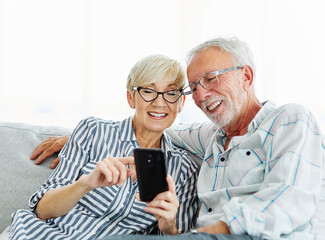 woman man senior retirement couple mobile phone phone home communication elderly adult happy...