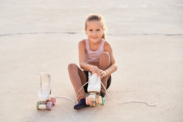 Smiling girl putting on roller skater