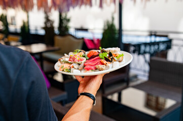 waiter hold Set Mixed Seafood on plate