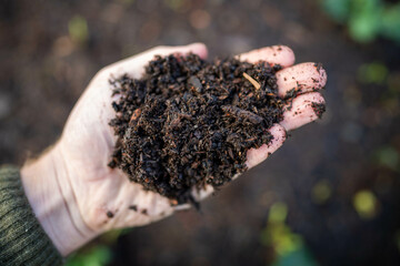  farmer holding soil looking at soil carbon in the america