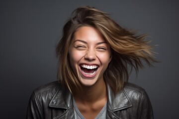 Headshot portrait photography of a happy girl in her 20s doing loser gesture mocking against a...
