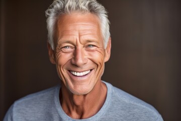 Close-up portrait photography of a happy mature man smiling against a beige background. With generative AI technology