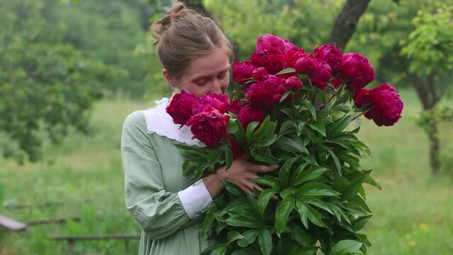 girl holding peonies flowers bouquet