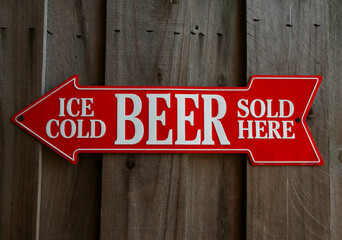 Ice Cold Beer Sold Here text in a red arrow