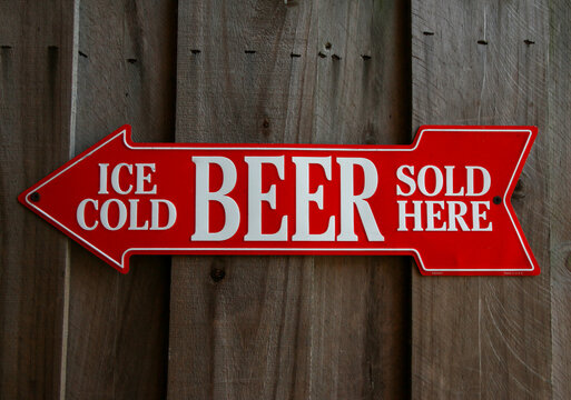 Ice Cold Beer Sold Here text in a red arrow
