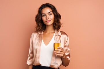 Medium shot portrait photography of a beautiful girl in her 20s holding a glass of champagne against a coral pink background. With generative AI technology