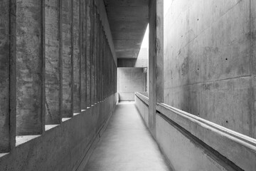 concrete building corridor in black and white photo