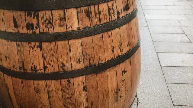 A barrel of wood made of wine boards stands on the street resin sealed. The concept of the winery