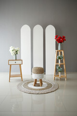 interior decoration of rattan chair and rattan rug with pink white board, bedside table and flower shelf